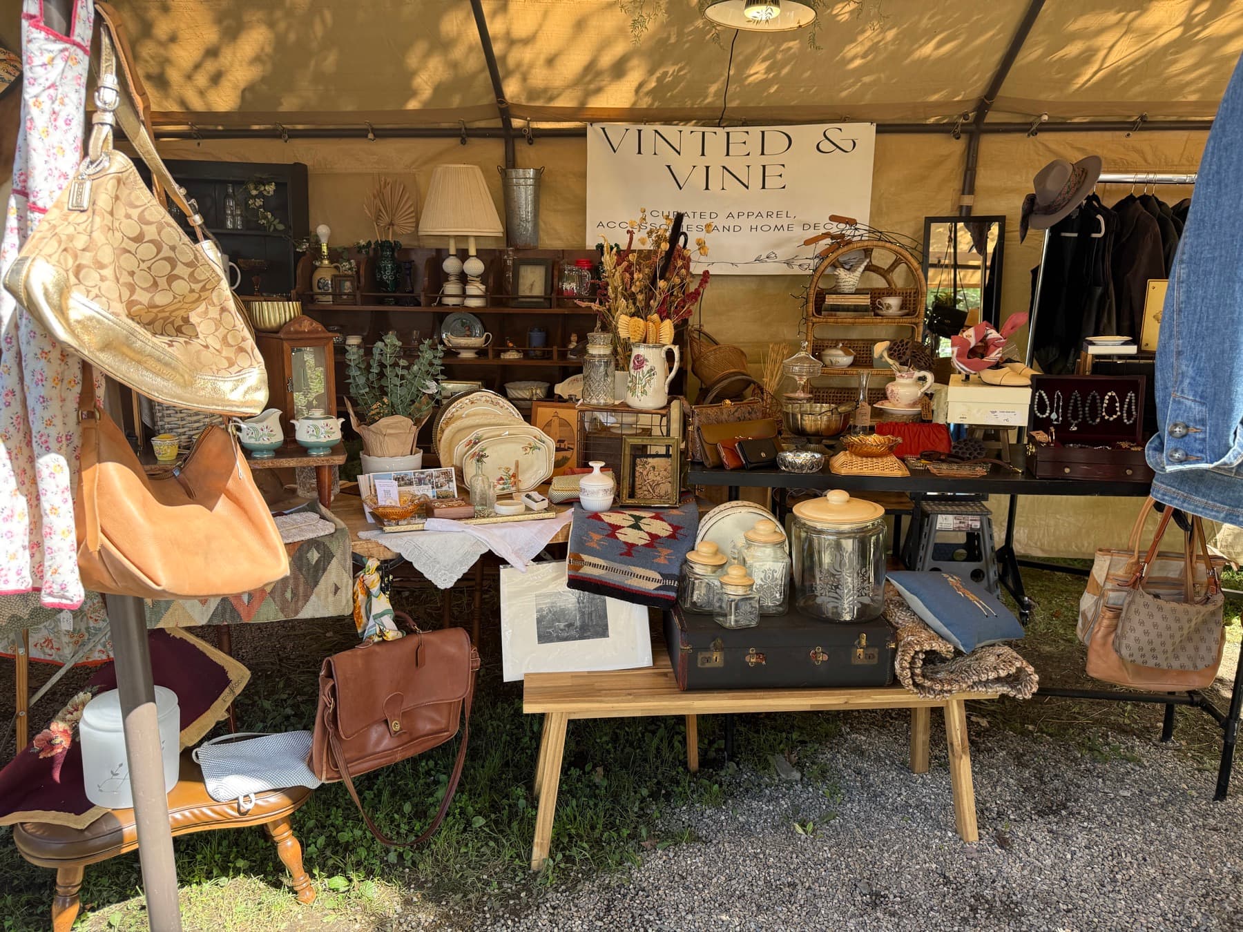 The Vinted and Vine booth banner advertising curated apparel, accessories and home decor at Brimfield