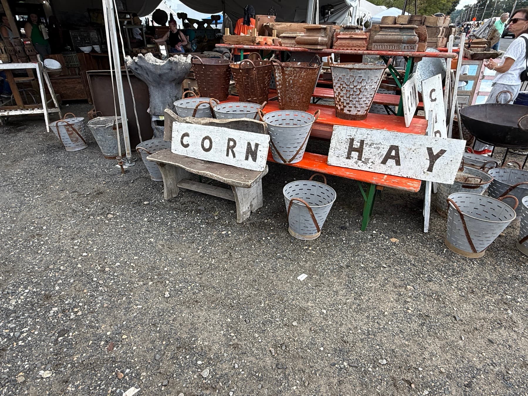 Rustic hand-painted CORN and HAY primitive signs displayed at a Brimfield booth