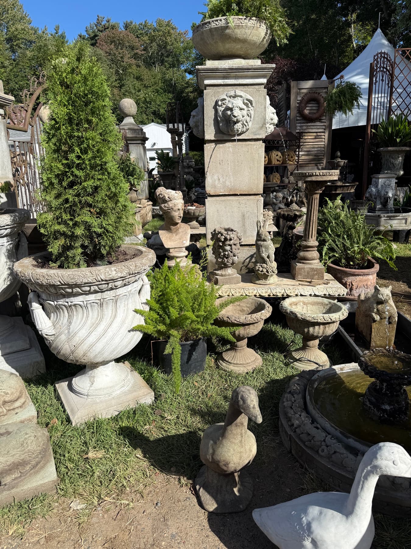 A garden fountain display with statuary at a Brimfield booth