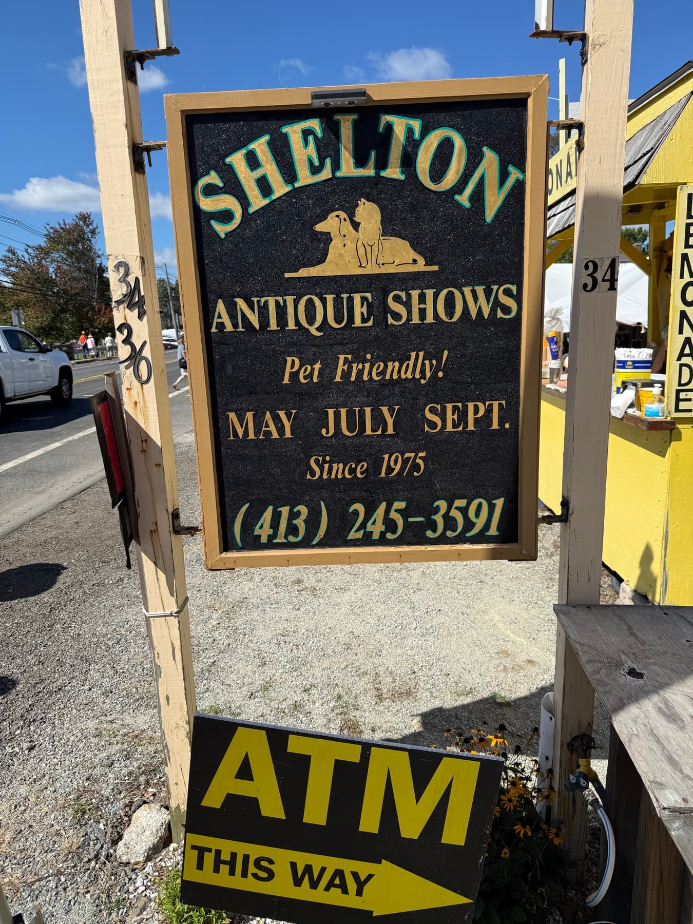 The official Shelton Antique Shows sign, pet-friendly since 1975, with an ATM sign underneath