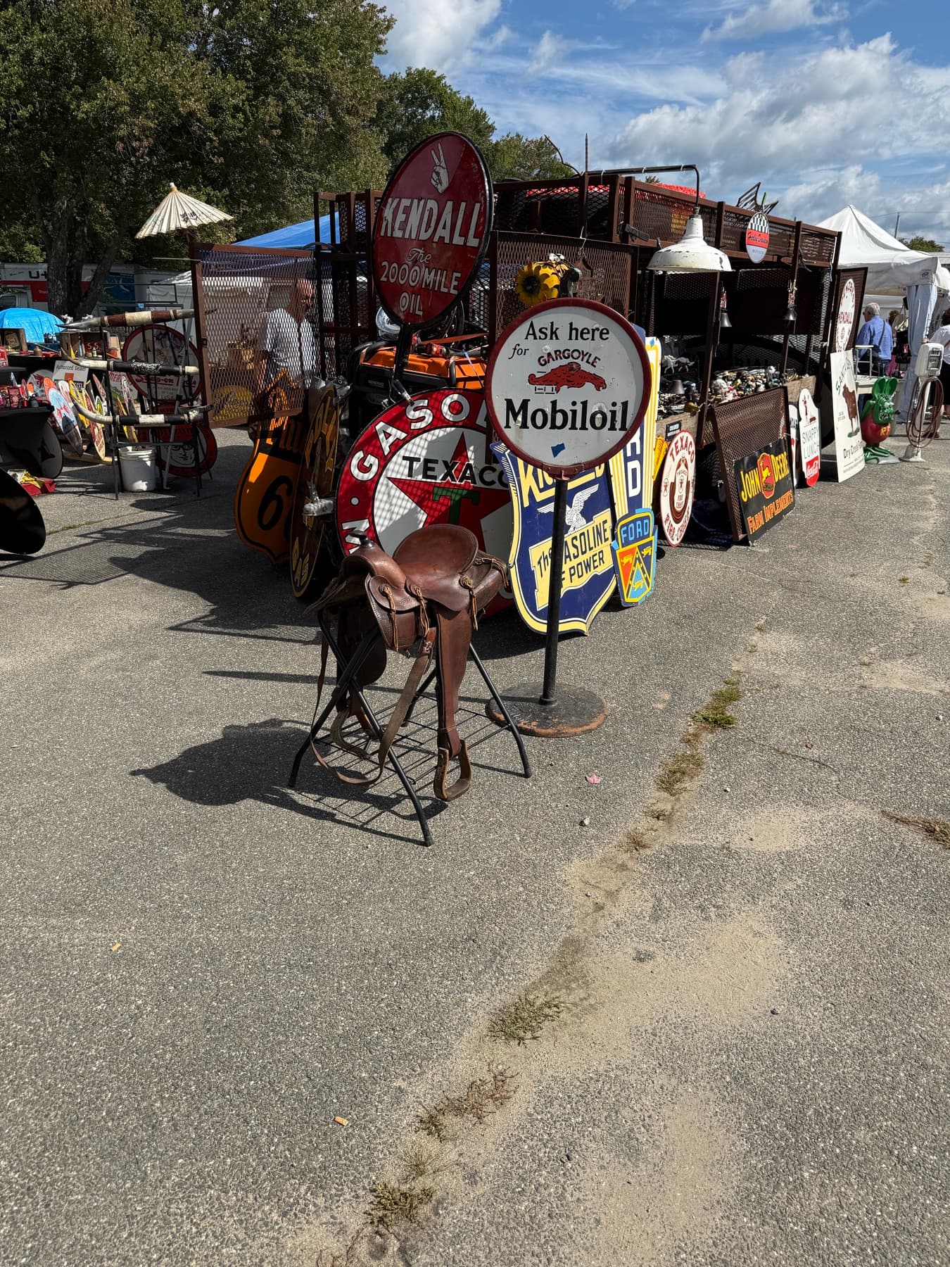 Vintage gas station and oil advertising signs including Kendall and Texaco at a Brimfield booth